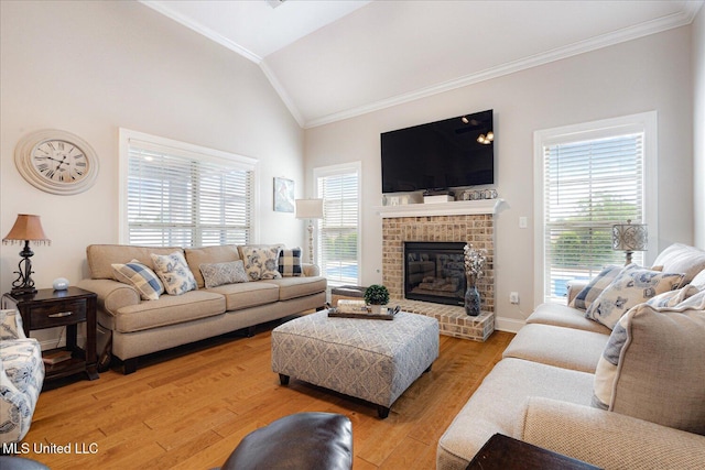 8063 Elizabeth Dr, Olive Branch, MS 38654 - living area with ornamental molding, lofted ceiling, a brick fireplace, light wood-style floors, and baseboards