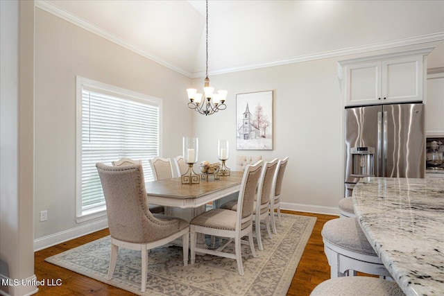 8063 Elizabeth Dr, Olive Branch, MS 38654 - dining room featuring a chandelier, plenty of natural light, wood finished floors, baseboards, and ornamental molding