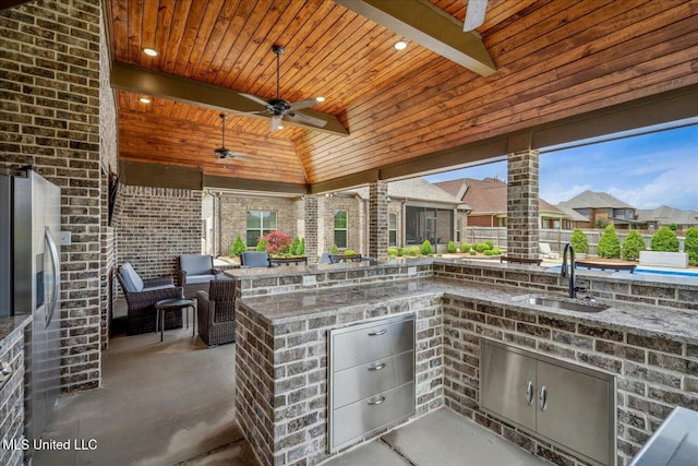 8063 Elizabeth Dr, Olive Branch, MS 38654 - view of patio featuring a sink, exterior kitchen, a ceiling fan, and a residential view