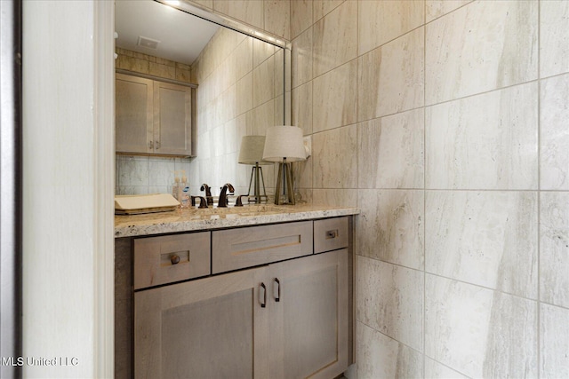 8063 Elizabeth Dr, Olive Branch, MS 38654 - bathroom featuring tile walls, vanity, and tasteful backsplash