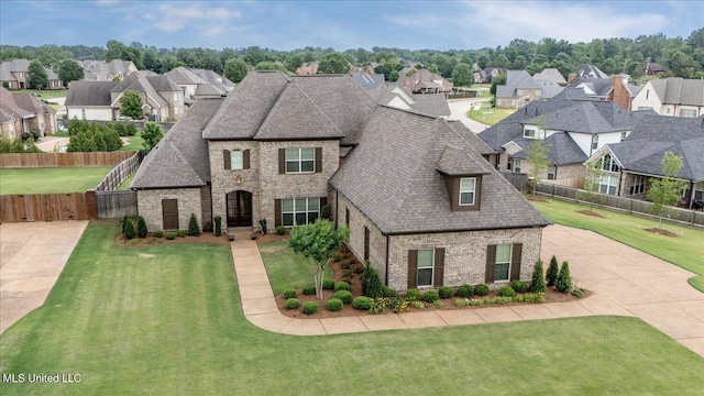 8063 Elizabeth Dr, Olive Branch, MS 38654 - french country style house featuring brick siding, a residential view, a shingled roof, and driveway