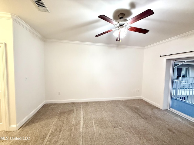 empty room with visible vents, baseboards, crown molding, and carpet