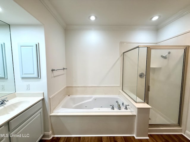 full bathroom featuring vanity, a shower stall, a whirlpool tub, and crown molding