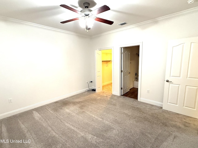 unfurnished bedroom featuring baseboards, visible vents, carpet floors, and ornamental molding