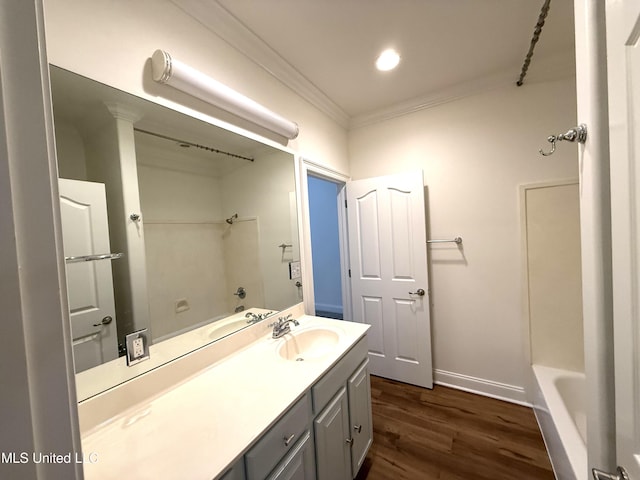 full bath with crown molding, baseboards, wood finished floors, a bath, and vanity