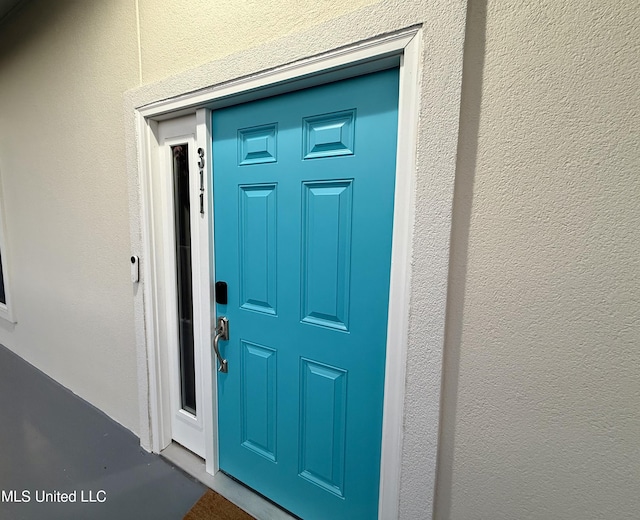 entrance to property with stucco siding