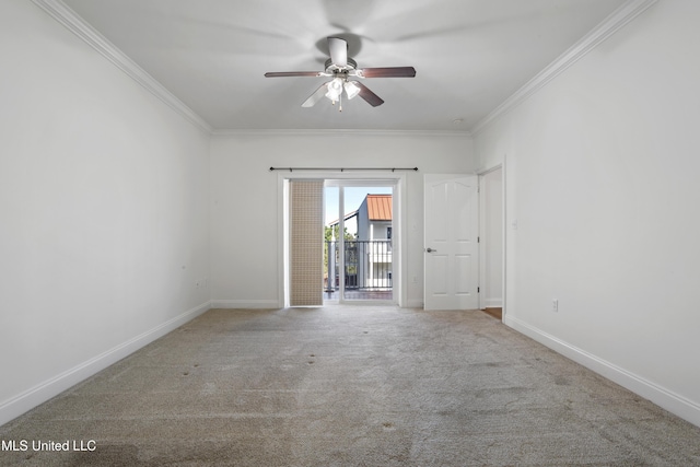 carpeted empty room featuring ceiling fan, crown molding, and baseboards