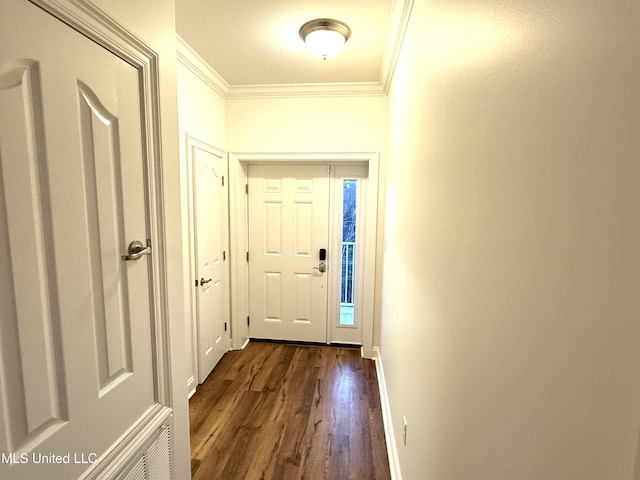 entryway featuring dark wood-type flooring, baseboards, and ornamental molding