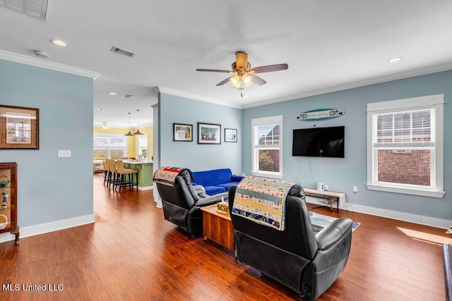 living room with crown molding, visible vents, and dark wood finished floors