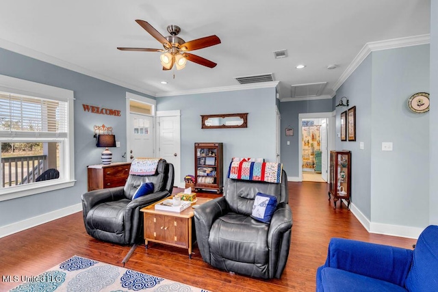 living room featuring baseboards, attic access, visible vents, and wood finished floors