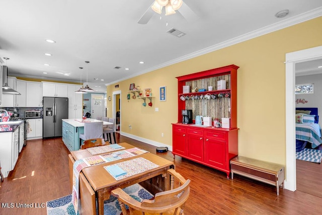 dining area featuring baseboards, visible vents, dark wood-style flooring, and crown molding