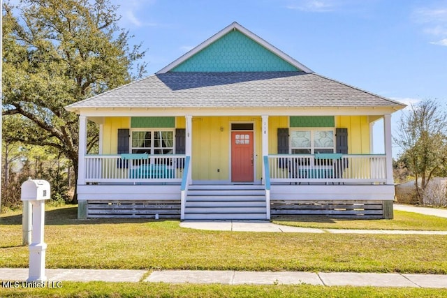 view of front of house featuring a porch, a shingled roof, and a front lawn