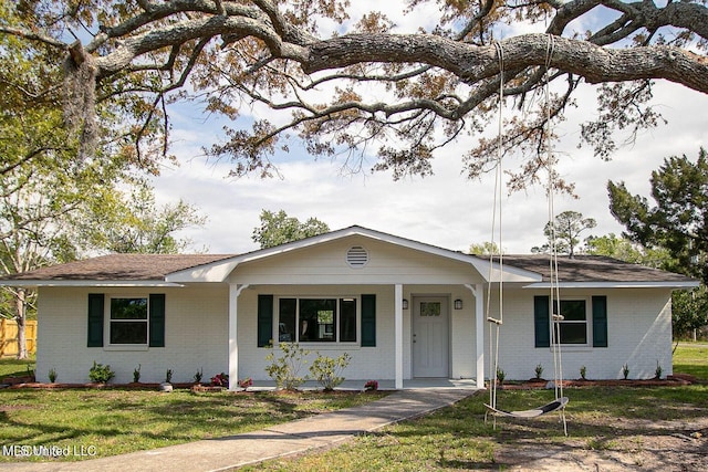 ranch-style home with a porch, a front lawn, and brick siding