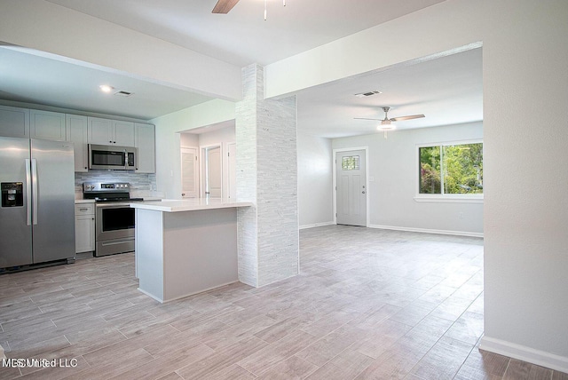 kitchen with ceiling fan, visible vents, light countertops, appliances with stainless steel finishes, and tasteful backsplash