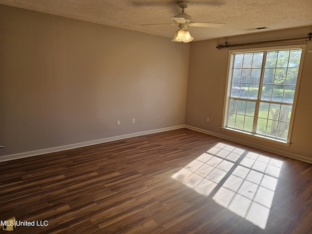 5746 Eagleston Dr, Olive Branch, MS 38654 - spare room featuring dark wood-type flooring, visible vents, and plenty of natural light