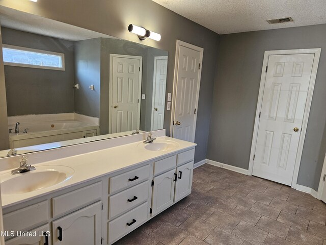 5746 Eagleston Dr, Olive Branch, MS 38654 - full bath featuring a textured ceiling, a sink, and visible vents