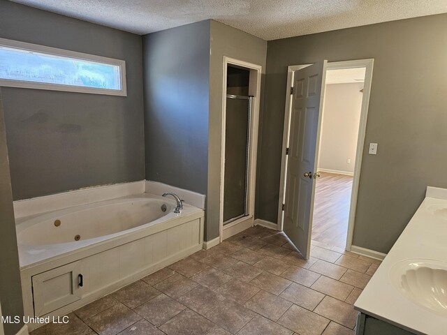5746 Eagleston Dr, Olive Branch, MS 38654 - bathroom featuring a whirlpool tub, a stall shower, and a textured ceiling