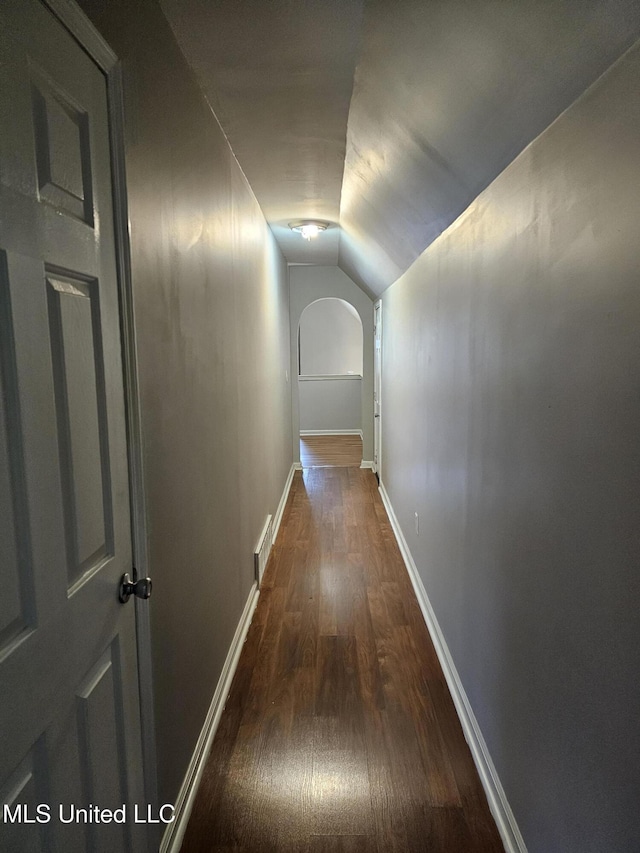 5746 Eagleston Dr, Olive Branch, MS 38654 - corridor featuring dark wood-type flooring, visible vents, baseboards, and lofted ceiling