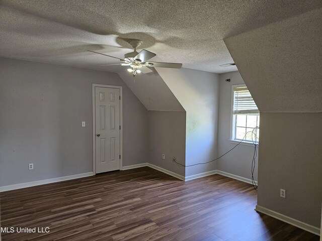 5746 Eagleston Dr, Olive Branch, MS 38654 - additional living space with dark wood-style flooring, a textured ceiling, a ceiling fan, and lofted ceiling