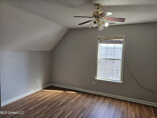 5746 Eagleston Dr, Olive Branch, MS 38654 - additional living space with dark wood-type flooring, baseboards, ceiling fan, and a textured ceiling