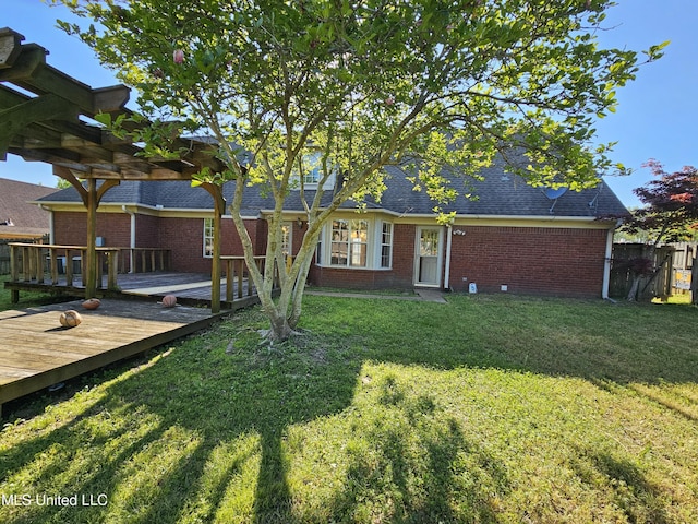 5746 Eagleston Dr, Olive Branch, MS 38654 - view of front of property featuring a front yard, a shingled roof, a deck, fence, and brick siding