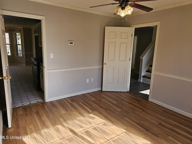 5746 Eagleston Dr, Olive Branch, MS 38654 - spare room with ornamental molding, a ceiling fan, and wood finished floors