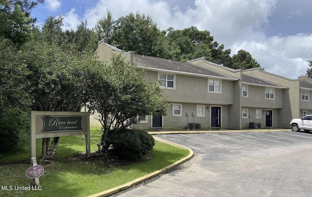 1625 Martin Bluff Rd Unit 97, Gautier, MS 39553 - view of front of house featuring stucco siding and uncovered parking