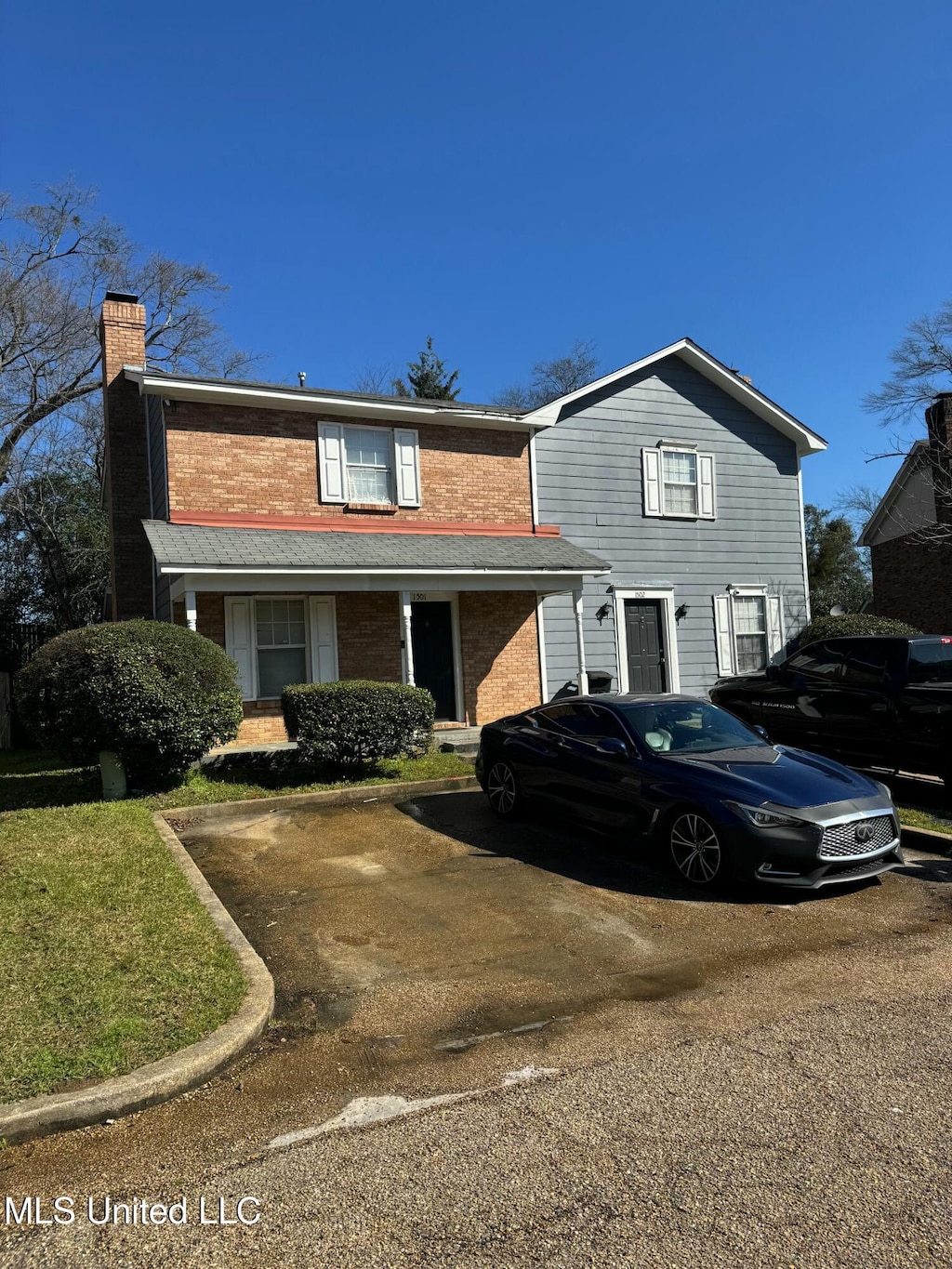 traditional-style home with brick siding and a chimney