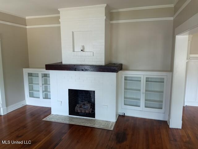 3 New St, Natchez, MS 39120 - unfurnished living room with wood finished floors, ornamental molding, and a brick fireplace