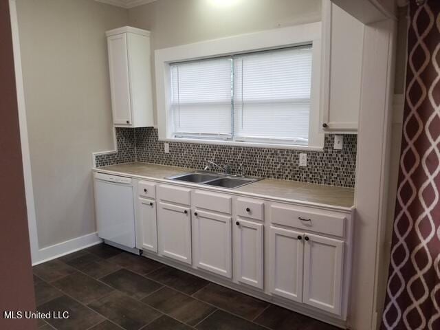3 New St, Natchez, MS 39120 - kitchen with dishwasher, decorative backsplash, white cabinetry, a sink, and light countertops