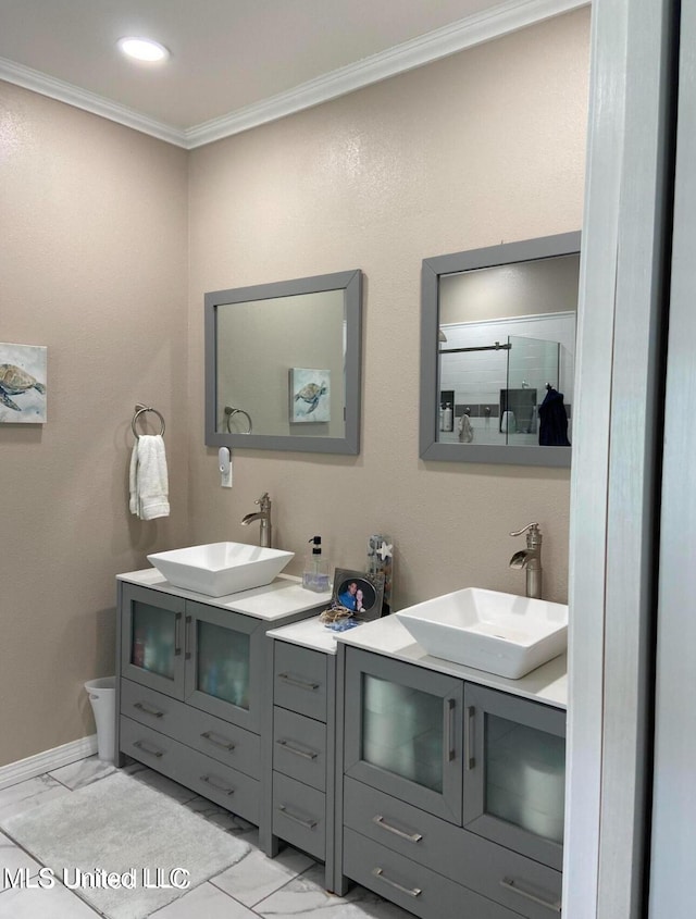bathroom featuring marble finish floor, a sink, and double vanity