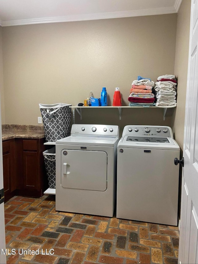 clothes washing area featuring independent washer and dryer, brick floor, cabinet space, and ornamental molding