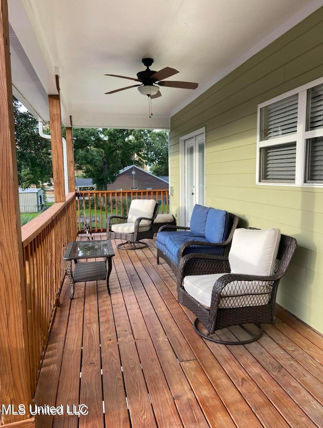 deck featuring a ceiling fan and an outdoor hangout area