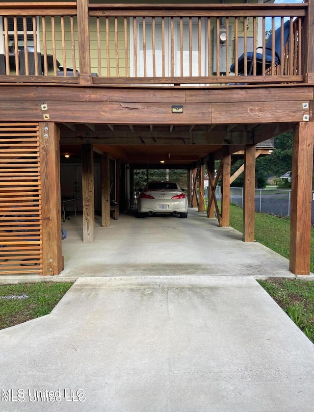 garage with concrete driveway and a carport