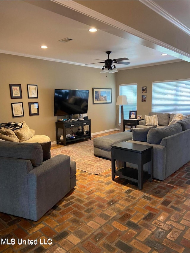 living room featuring crown molding, brick floor, and baseboards