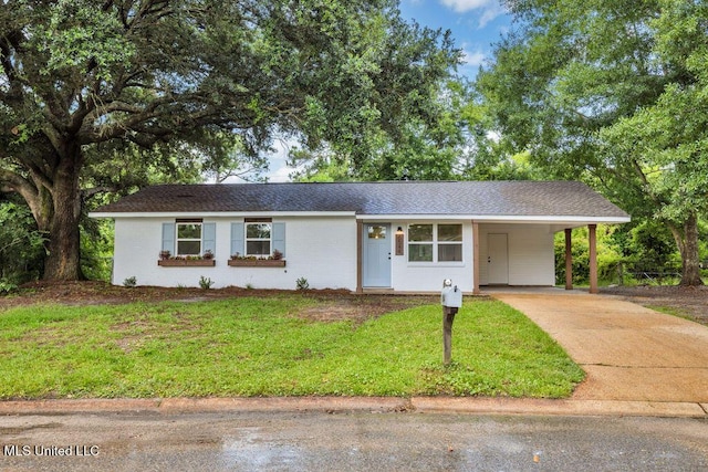 6544 Columbus Cir, Ocean Springs, MS 39564 - ranch-style house featuring concrete driveway, a front lawn, a carport, and brick siding