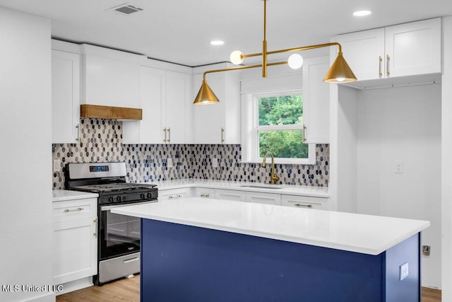 6544 Columbus Cir, Ocean Springs, MS 39564 - kitchen with stainless steel range with gas cooktop, white cabinetry, light countertops, and recessed lighting