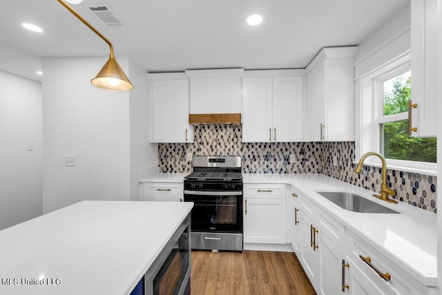 6544 Columbus Cir, Ocean Springs, MS 39564 - kitchen featuring stainless steel appliances, light countertops, tasteful backsplash, wood finished floors, and recessed lighting