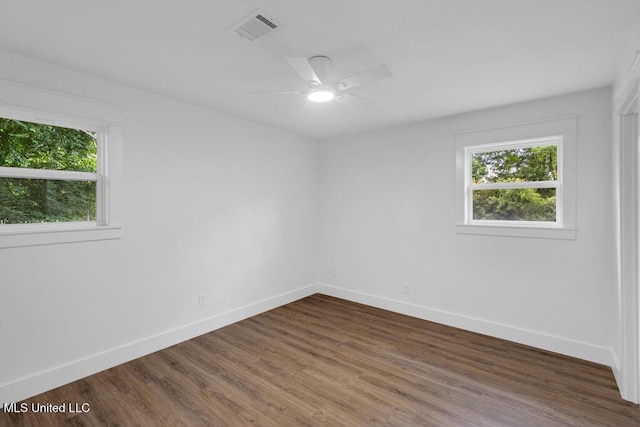 6544 Columbus Cir, Ocean Springs, MS 39564 - empty room featuring healthy amount of natural light, dark wood-style flooring, and a ceiling fan