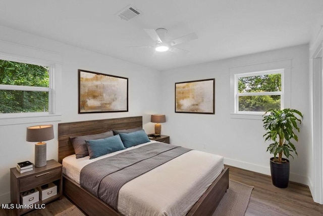 6544 Columbus Cir, Ocean Springs, MS 39564 - bedroom featuring multiple windows, wood finished floors, and a ceiling fan