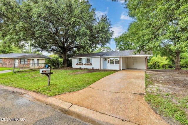 6544 Columbus Cir, Ocean Springs, MS 39564 - ranch-style home with driveway, a front lawn, and an attached carport
