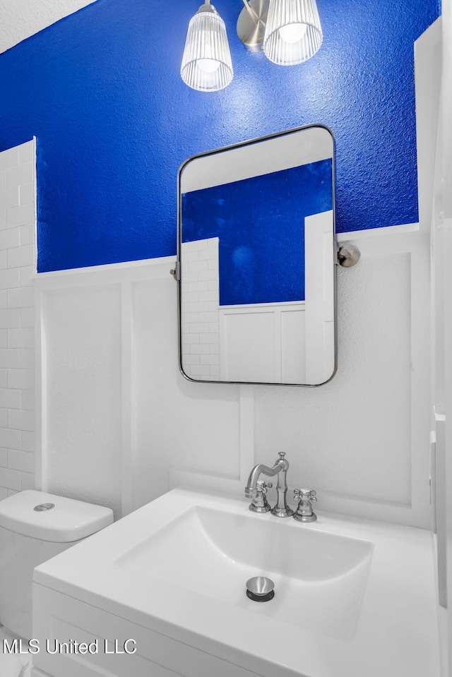 6544 Columbus Cir, Ocean Springs, MS 39564 - bathroom with wainscoting and vanity
