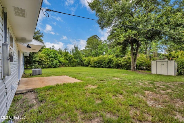 6544 Columbus Cir, Ocean Springs, MS 39564 - view of grassy yard featuring a storage shed, a patio, and view of wooded area
