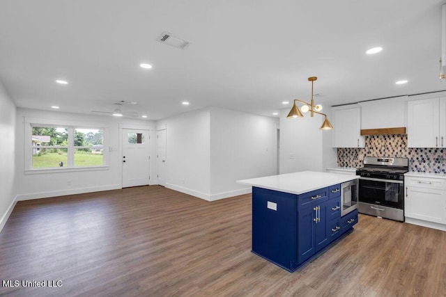 6544 Columbus Cir, Ocean Springs, MS 39564 - kitchen featuring stainless steel appliances, blue cabinets, white cabinetry, recessed lighting, and wood finished floors