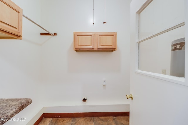 washroom with baseboards and stone finish flooring