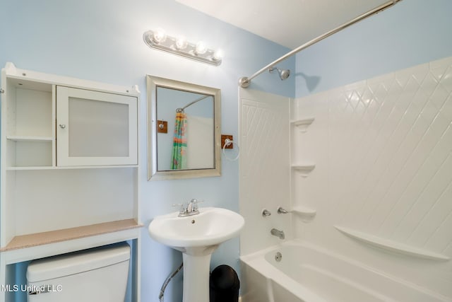 bathroom featuring a sink, toilet, and bathtub / shower combination