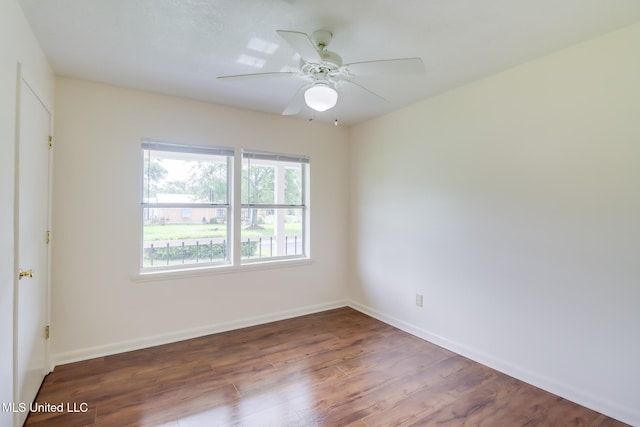 unfurnished room featuring ceiling fan, baseboards, and wood finished floors