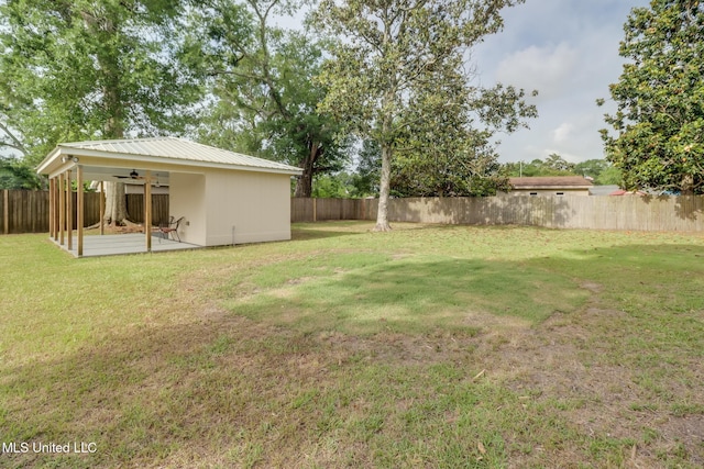 view of yard featuring a patio area, a fenced backyard, and ceiling fan