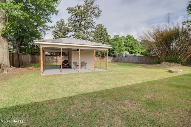view of yard featuring a patio area, ceiling fan, and a fenced backyard
