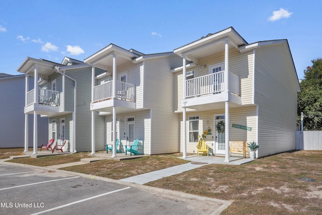 view of front of house featuring a patio and a balcony